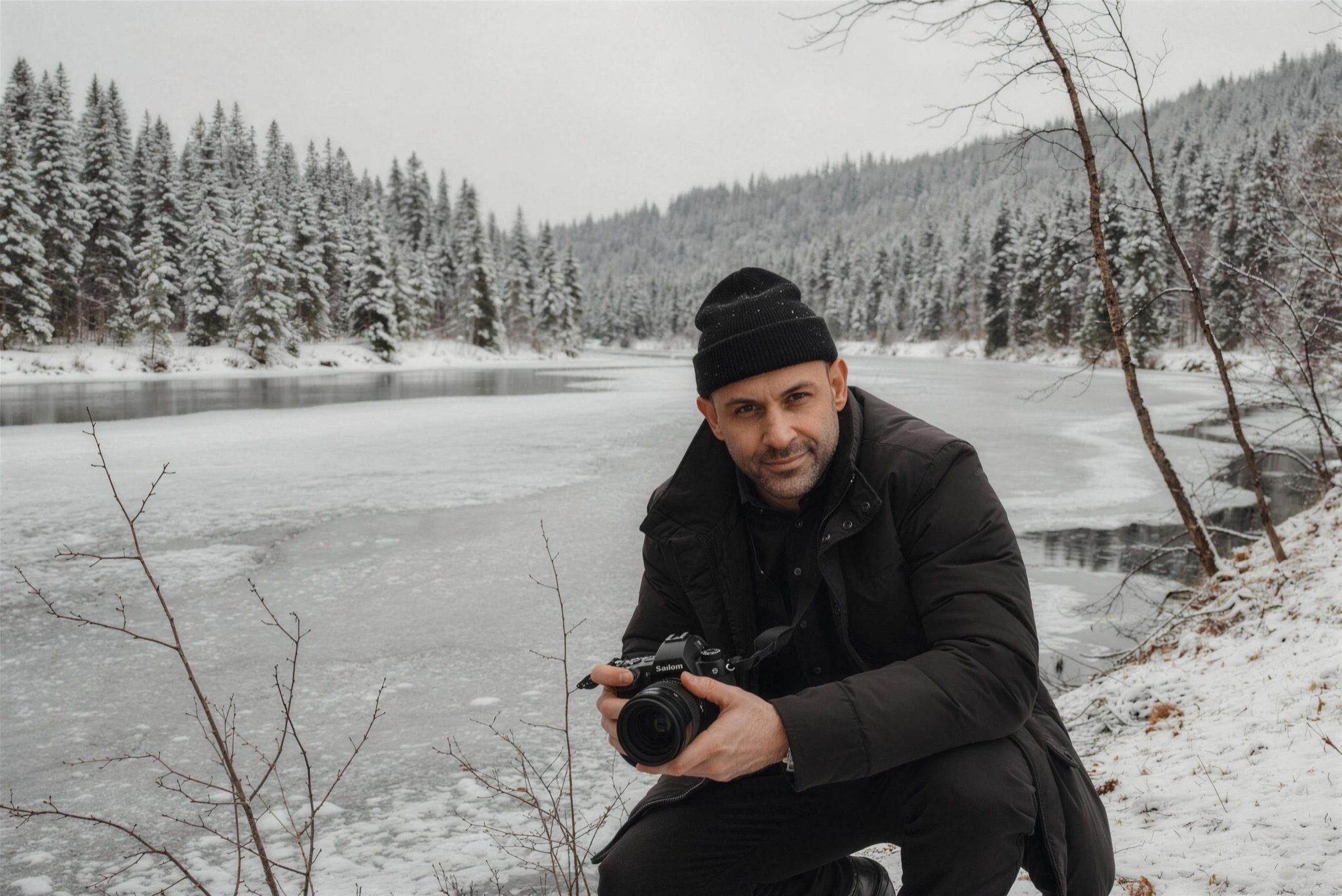 The photographer at work by a frozen river in Norrbotten