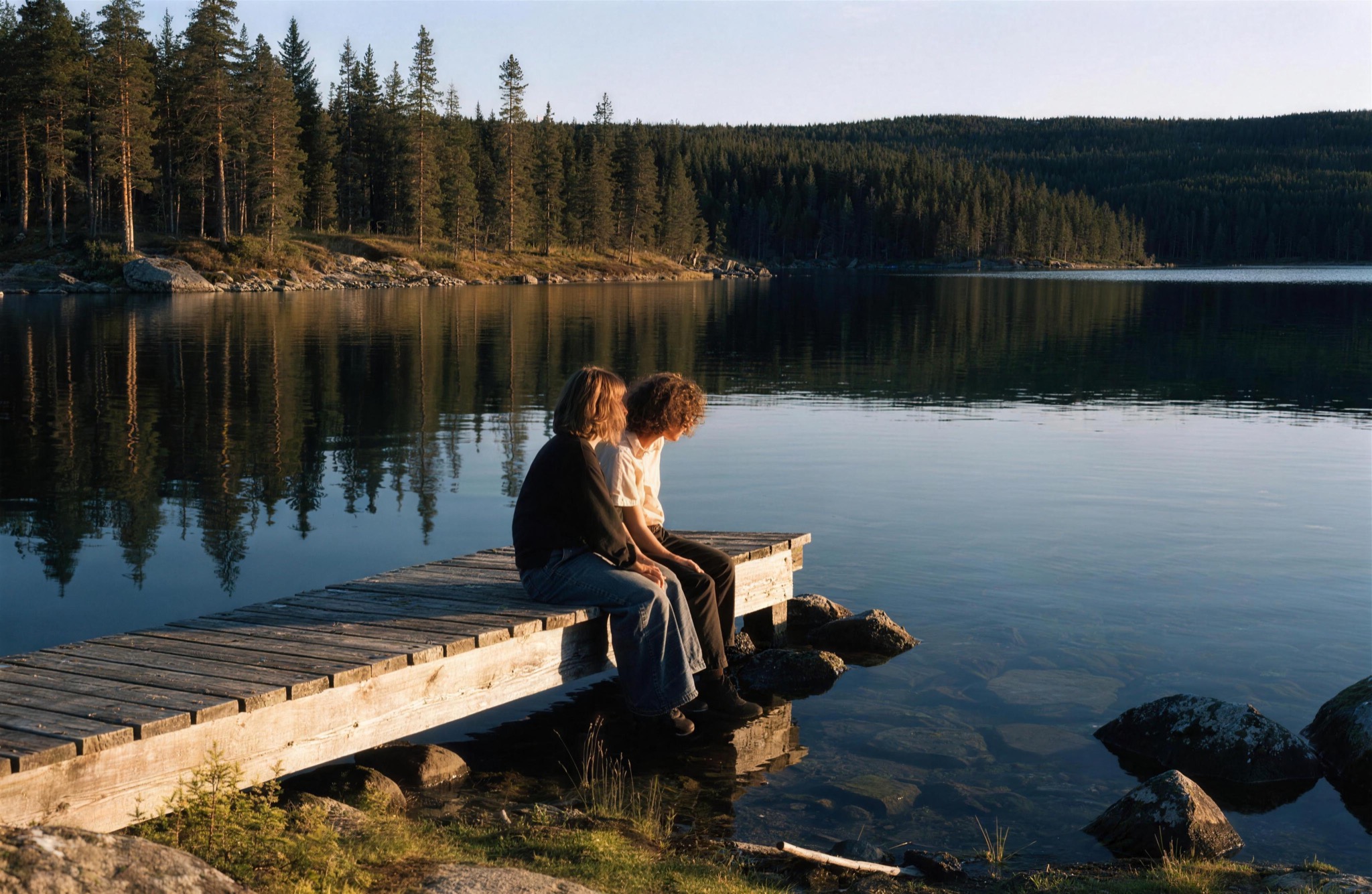 A couple on a jetty in the midnight sun